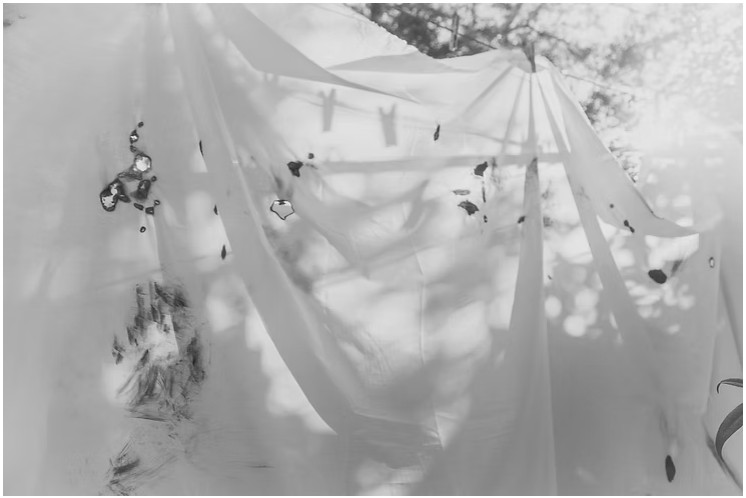 My interest in incorporating fire into LEVO began in a tangle of metaphorical leads. Fire is as profoundly crippling as it is a vital tool. It both serves and stimulates anxiety. With lit incense sticks I laboriously stubbed hot ash into the fiber to make small but conspicuous holes. But in the hopes of increased efficiency, I eventually turned to the miniature butane torch. With the help of my Dad, I applied controlled jets of flame to the fabric at up to 1300 degrees Celsius. I hoped these markings might underpin events and metaphors for my practice-led research on anxiety and sanative making. Destruction/creation. Balance, restoration. Action, and the ruination of one form for another. 

In the Iliad, an aggrieved and raging Achilles is likened to a fire meeting devastation to anything in its path. But here, on a sunny Australian July, under the auspices of the old gum tree I climbed as a kid, Dad and I worked into the white cotton fabric with careful elemental allowance. It was a pleasant return to place and I turned peacefully to the creative push/pull - what is taken/what is left. This limited combustion of fibers is a part of material learning, an arresting occupancy and a larger material and metaphorical study. Where does process start? Why is the elected process elevated over other media? When does its use cease? What can it mean?