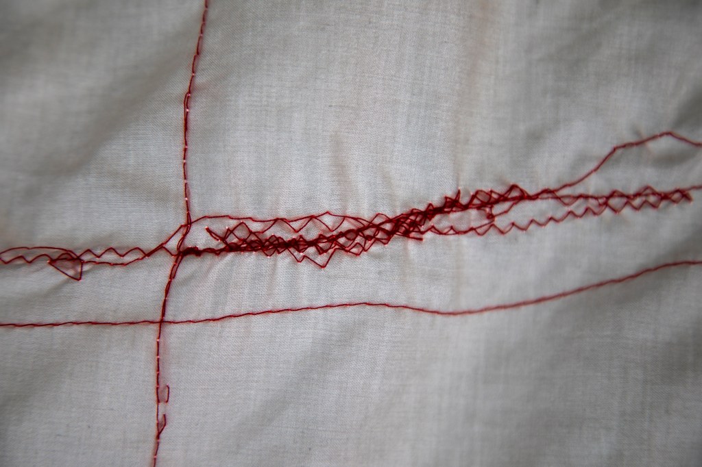 an abstract landscape of textiles sewn together. Bed sheets and other sleep-related cloth are torn and collaged to create a new work that reflects on the nature of sleep, narcolepsy and chronic illness.