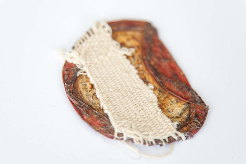 A woven hand found object created sculpture metal thread by textile artist megan kennedy for petite exhibition